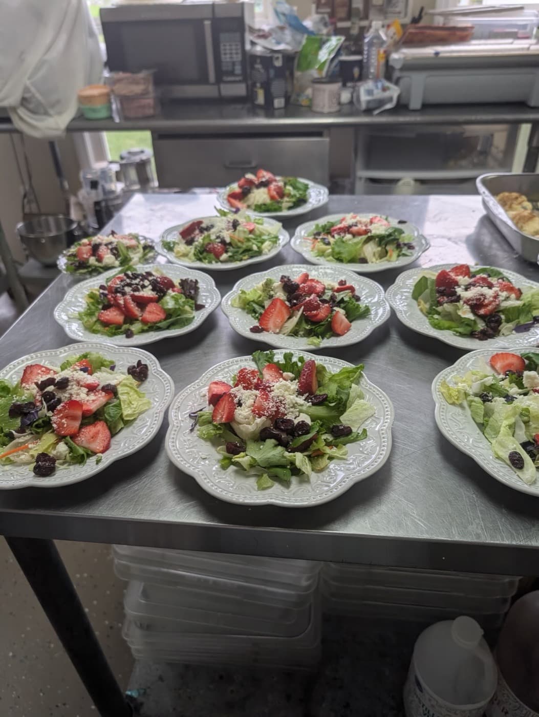 Plated salads with strawberry and feta, ready to serve